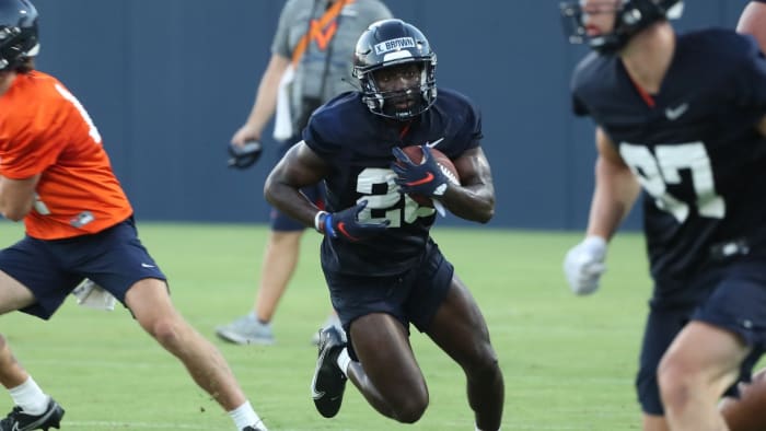 Freshman running back Xavier Brown carries the ball during Virginia football fall camp.
